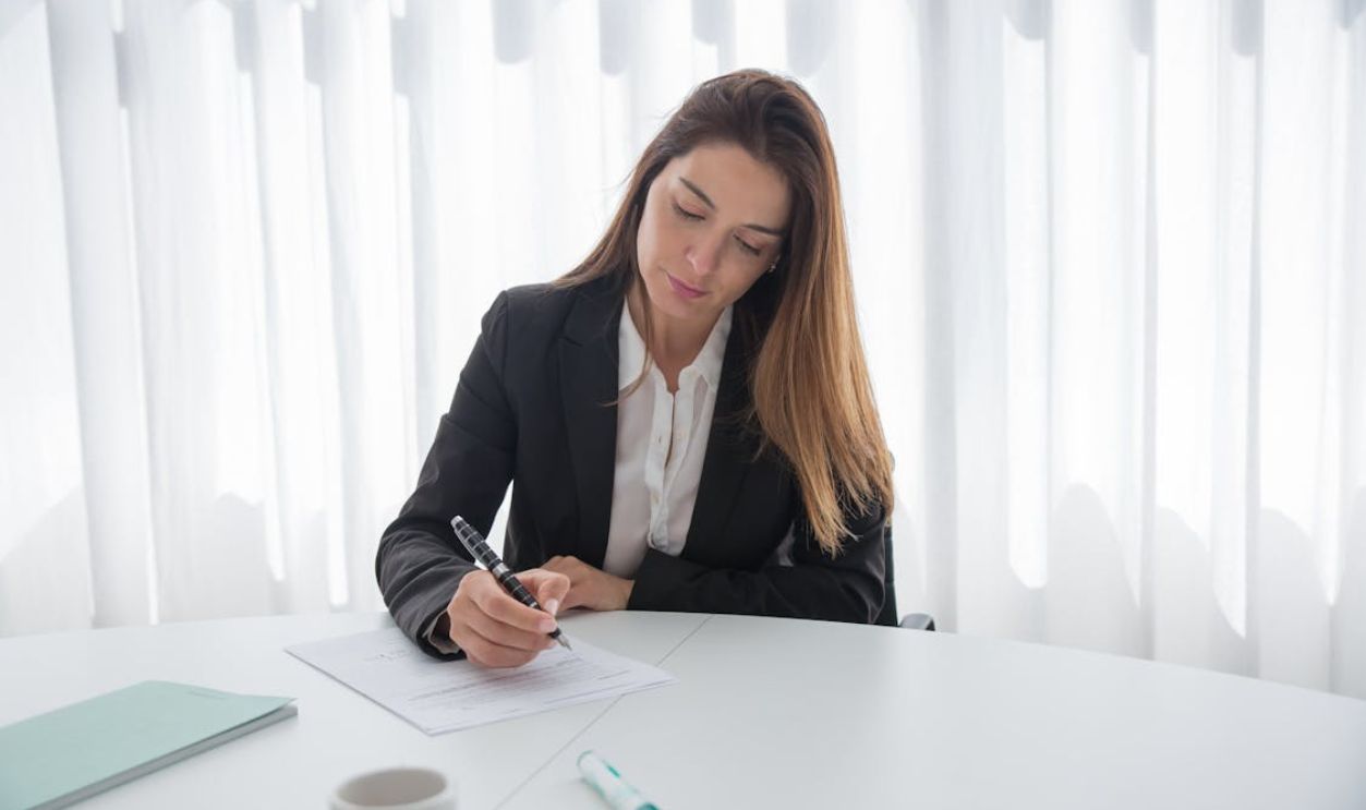Businesswoman Signing Document