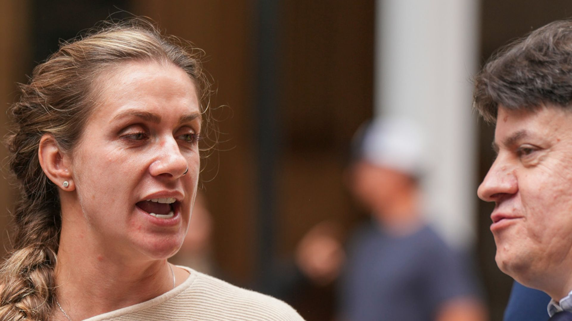 Woman with braid talking to two people