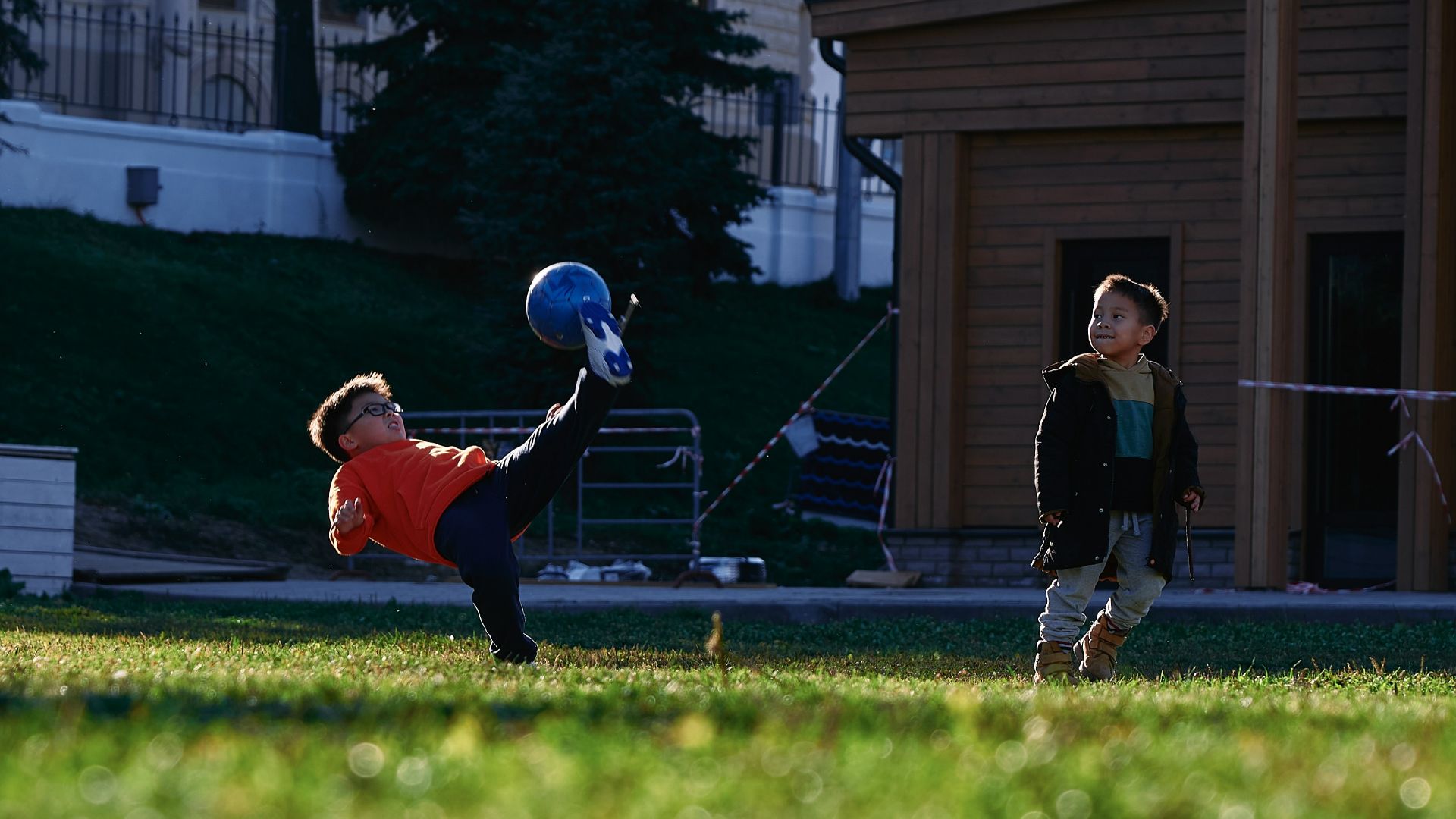 a small child swinging a bat at a ball