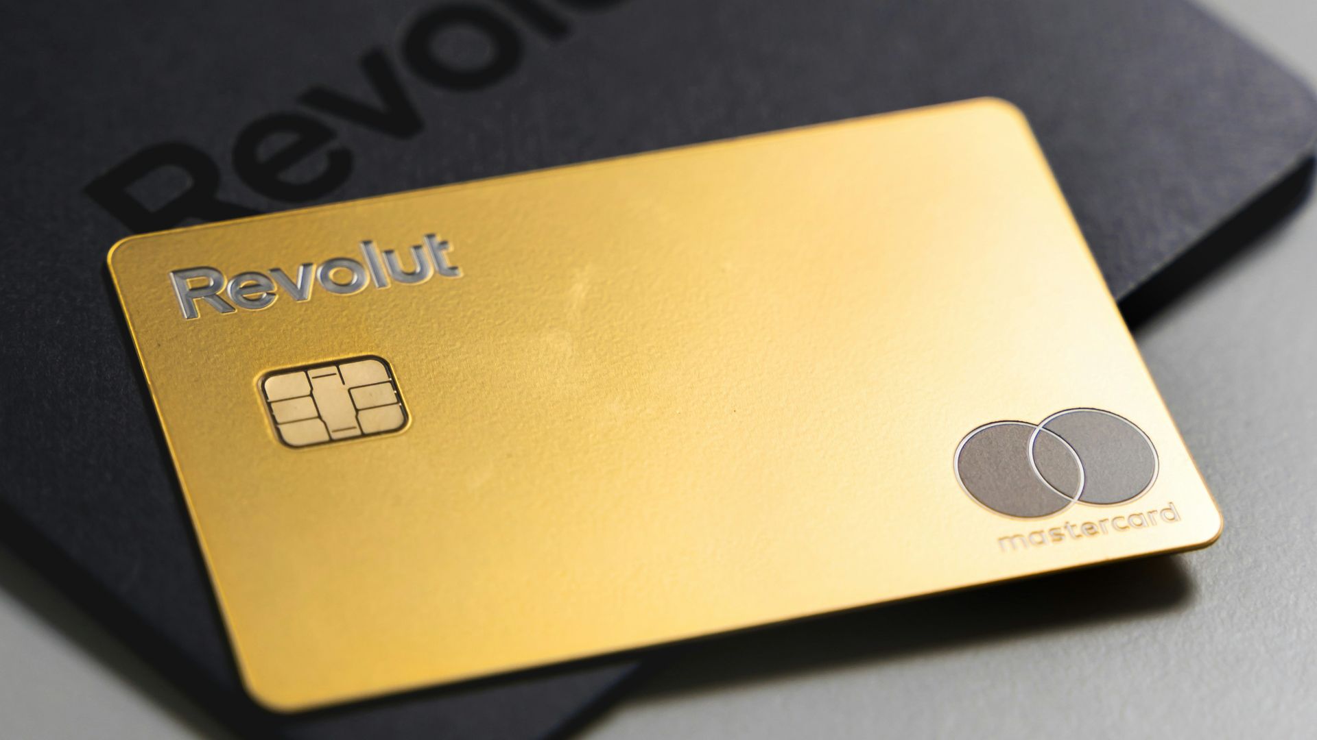 a black and gold credit card sitting on top of a table