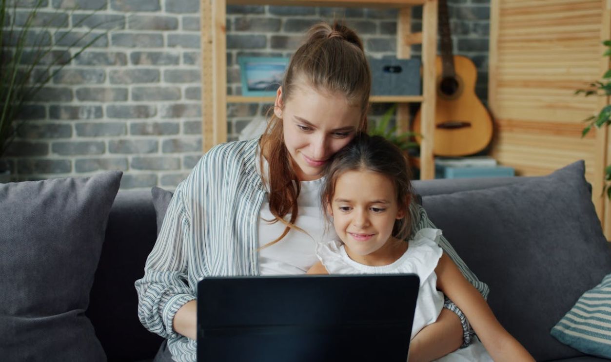 Mother and Daughter Using Laptop at Home