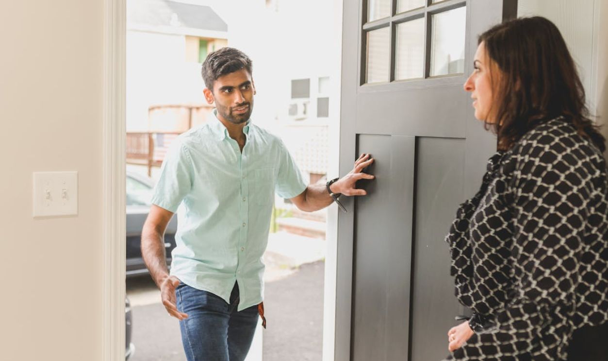 A Man Talking to a Woman on a Doorway