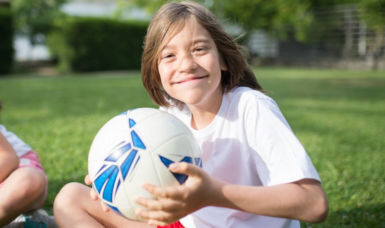 A Happy Boy Holding a Football
