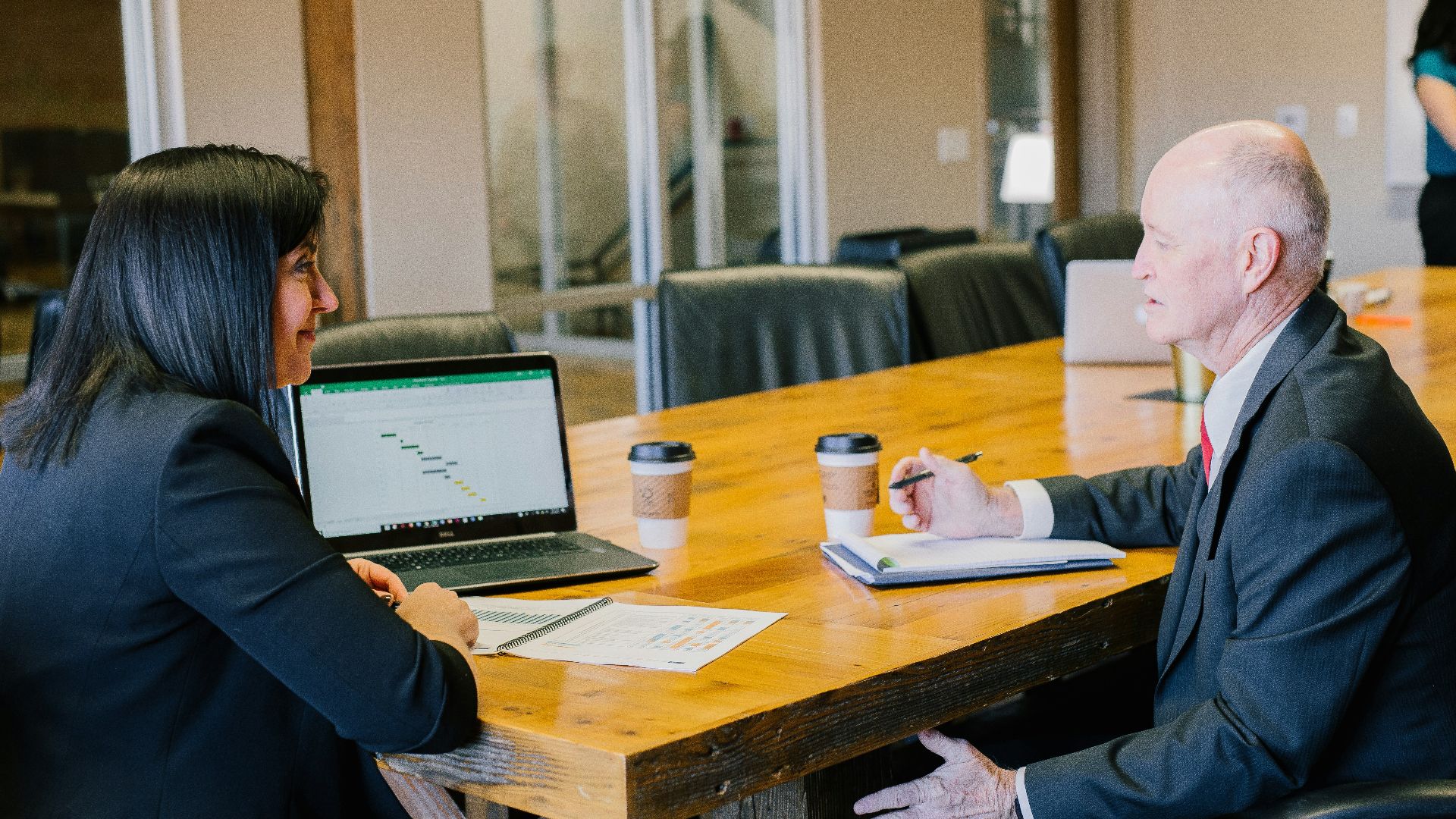 woman in black long sleeve shirt using black tablet computer