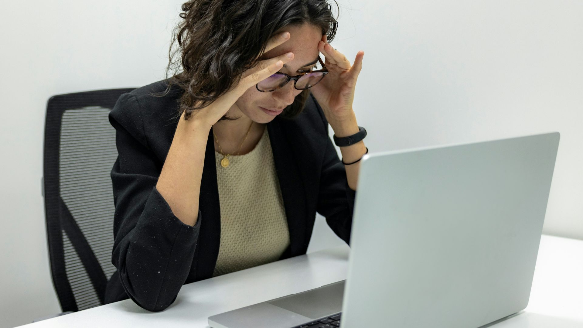 a woman sitting in front of a laptop computer