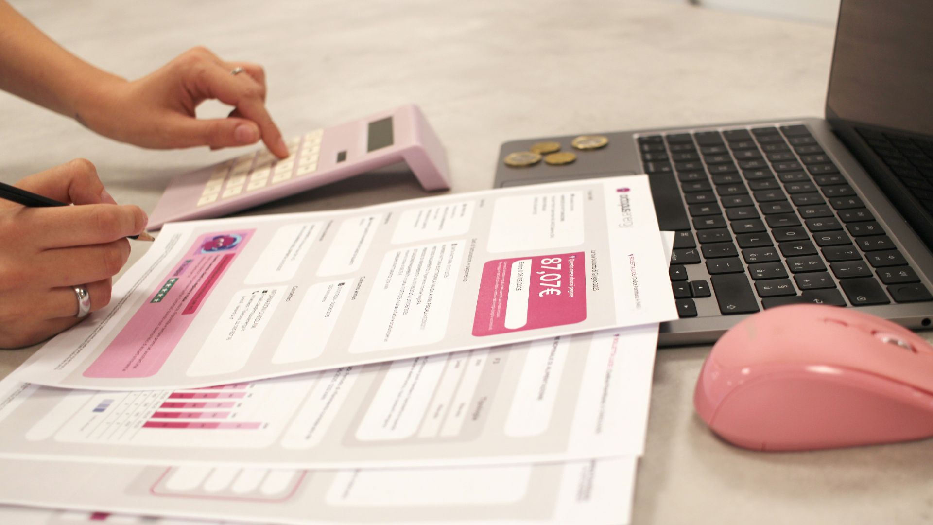 Someone is calculating bills with a calculator.