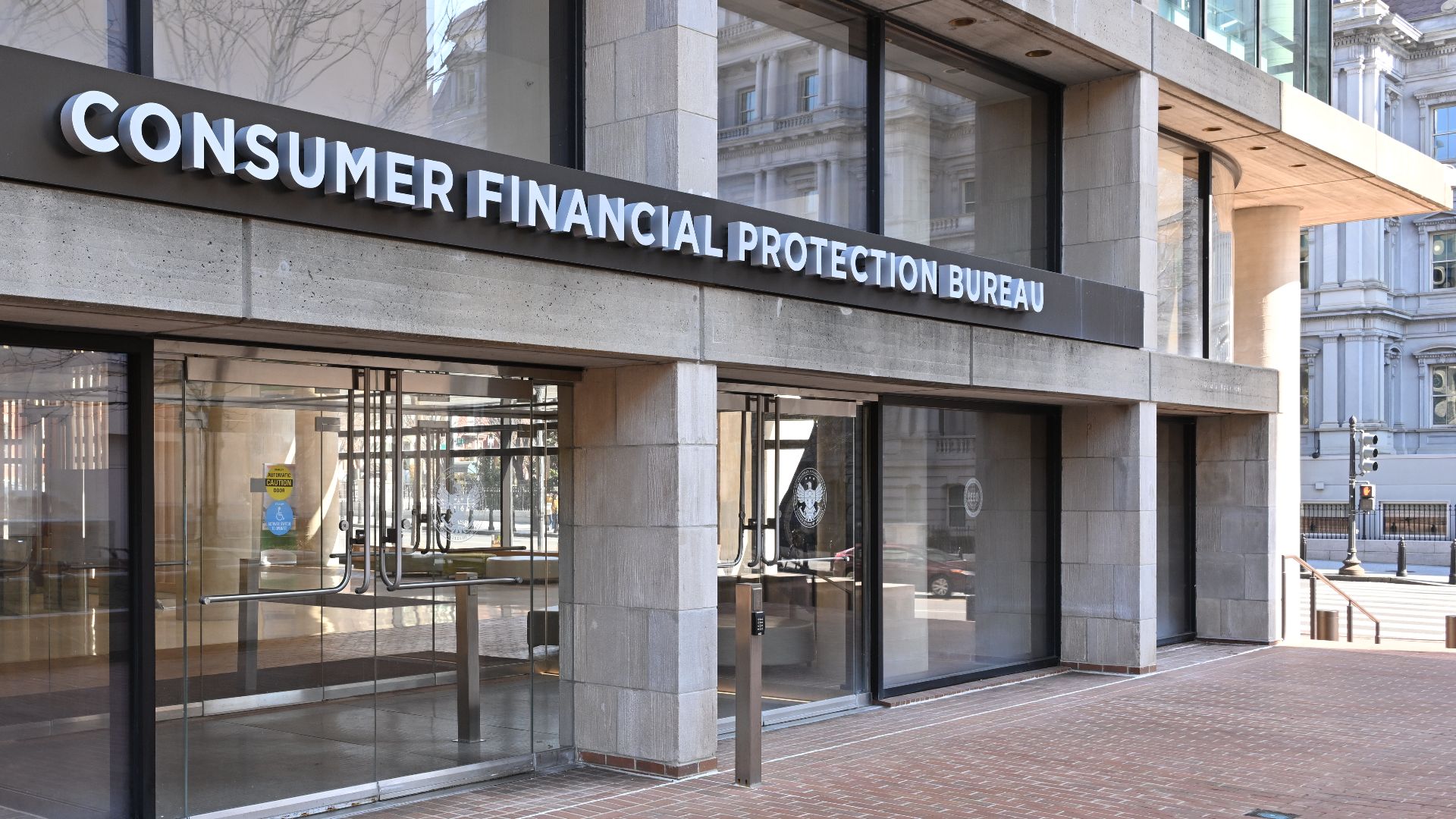 The entrance to the Consumer Financial Protection Bureau headquarters with the bureau's name above it. 1700 G Street NW, Washington, DC 20552.