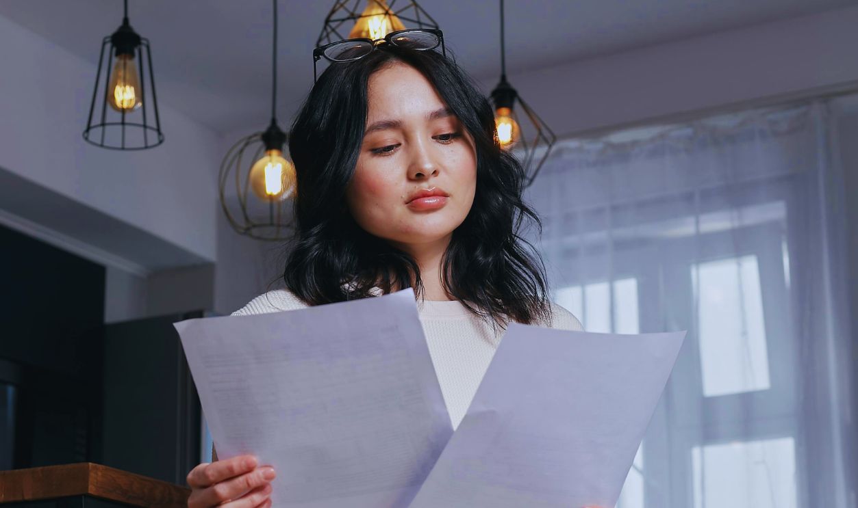 A Woman Holding White Printer Paper