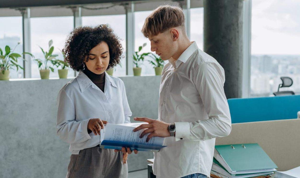Coworkers Reading Documents in the Office