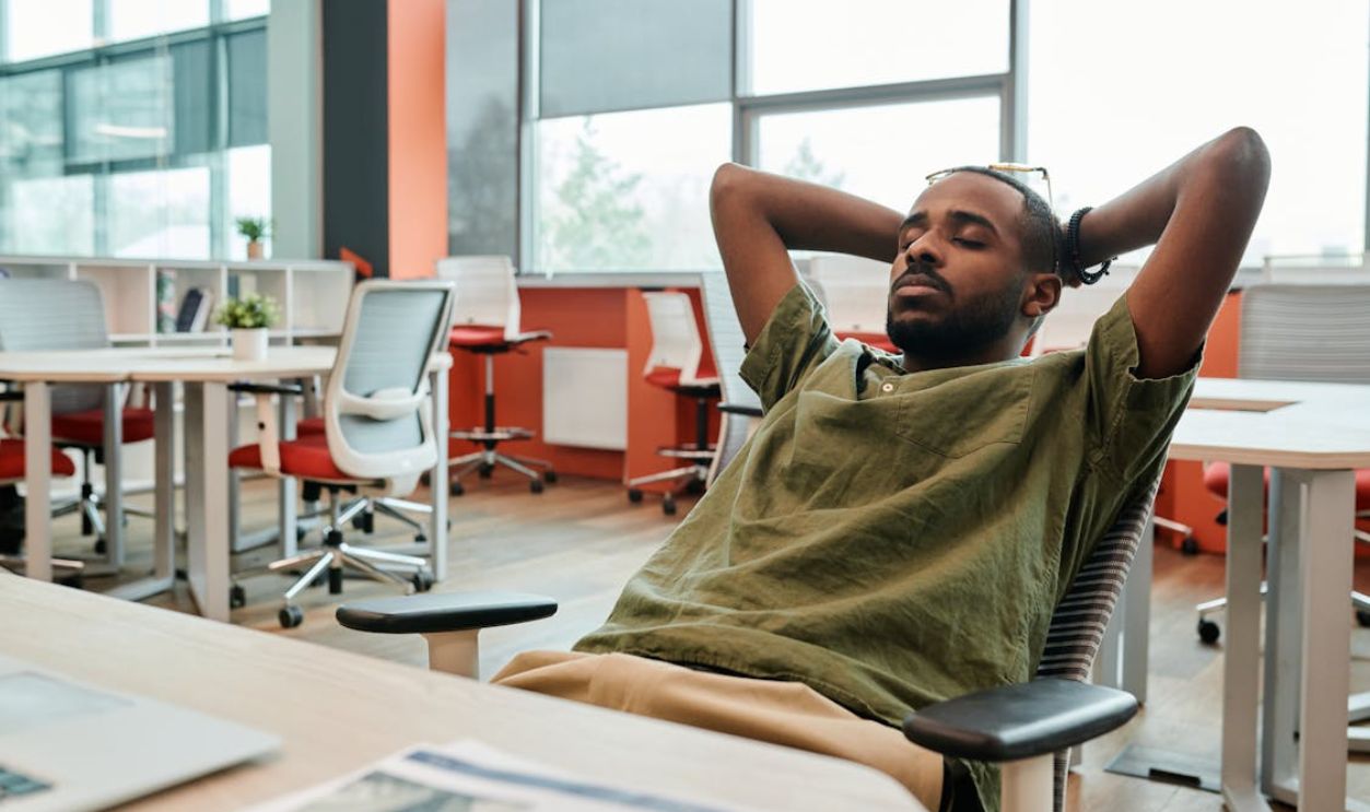 A Man Resting on the Chair with His Eyes Closed