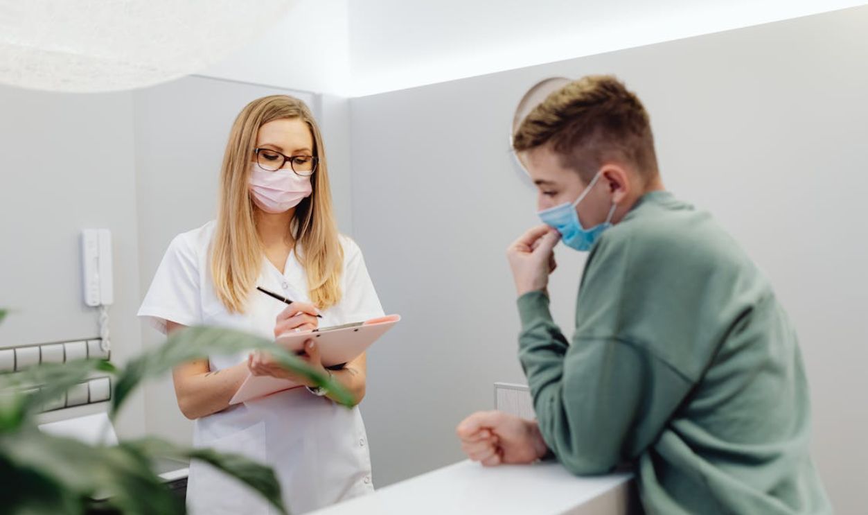 Man and Woman Standing Near the Table