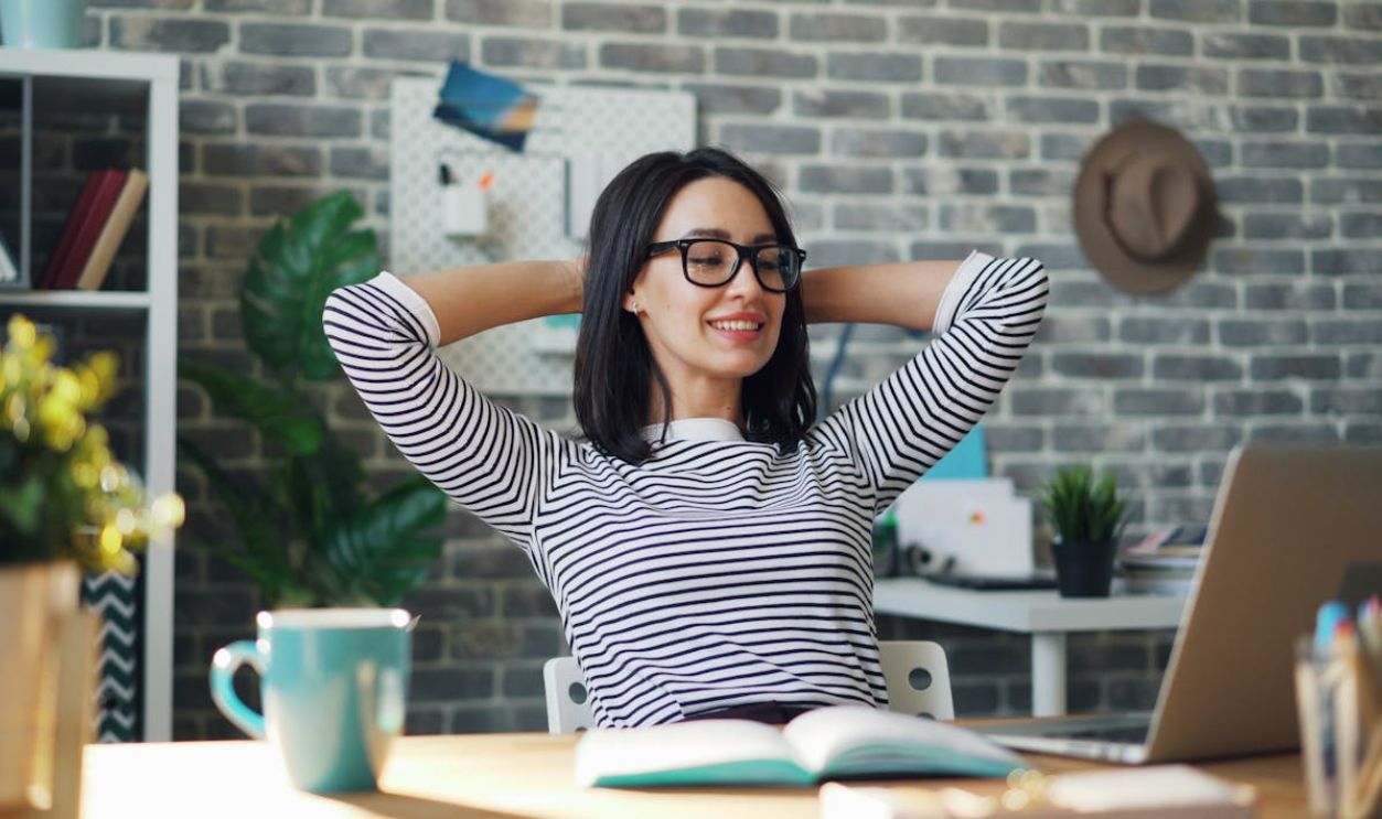 Young Woman Using a Laptop in a Modern Office