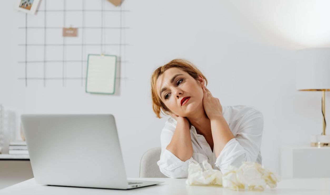 A Bored Woman Looking at the MacBook Laptop