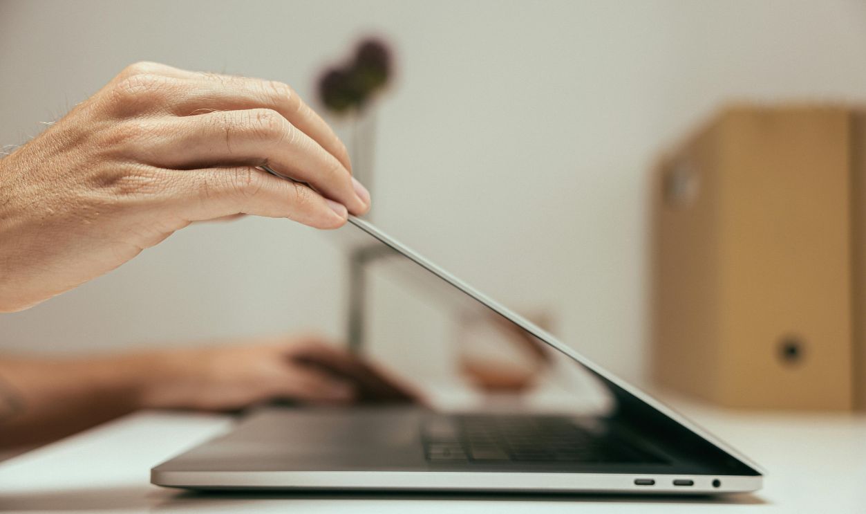 Person Opening a Laptop