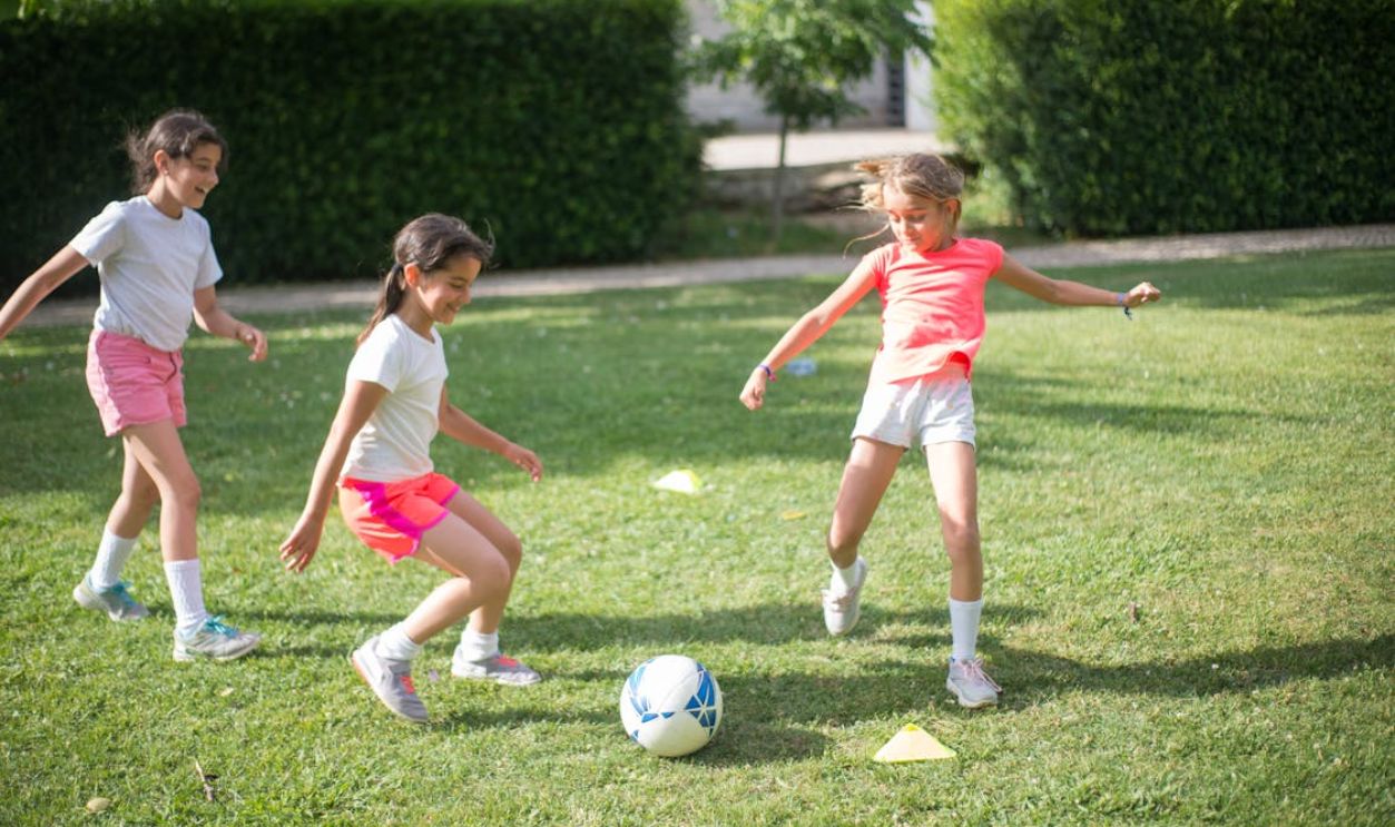 A Group of Girls Playing Football on the Field