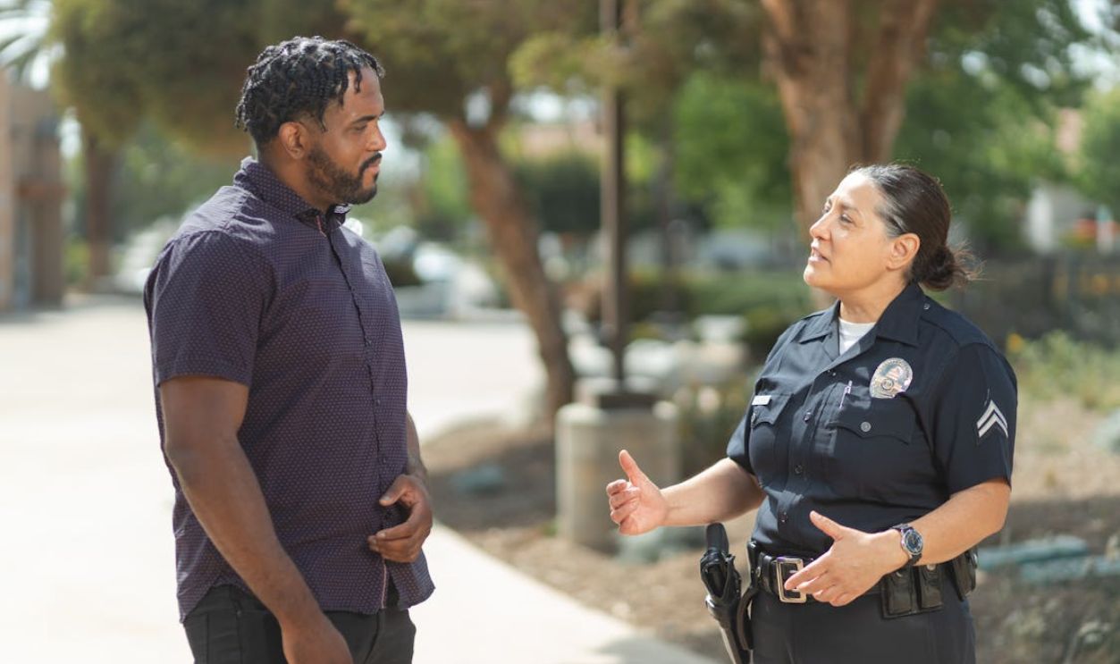 Man and Policewoman Talking in the Street