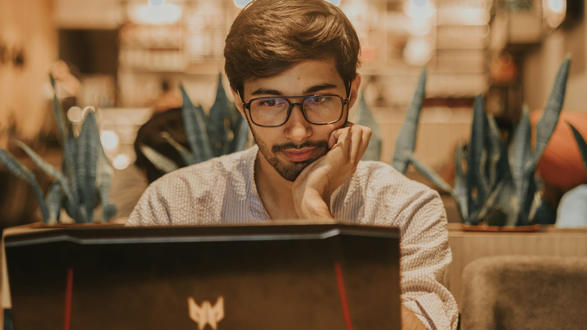 a man sitting in front of a laptop computer