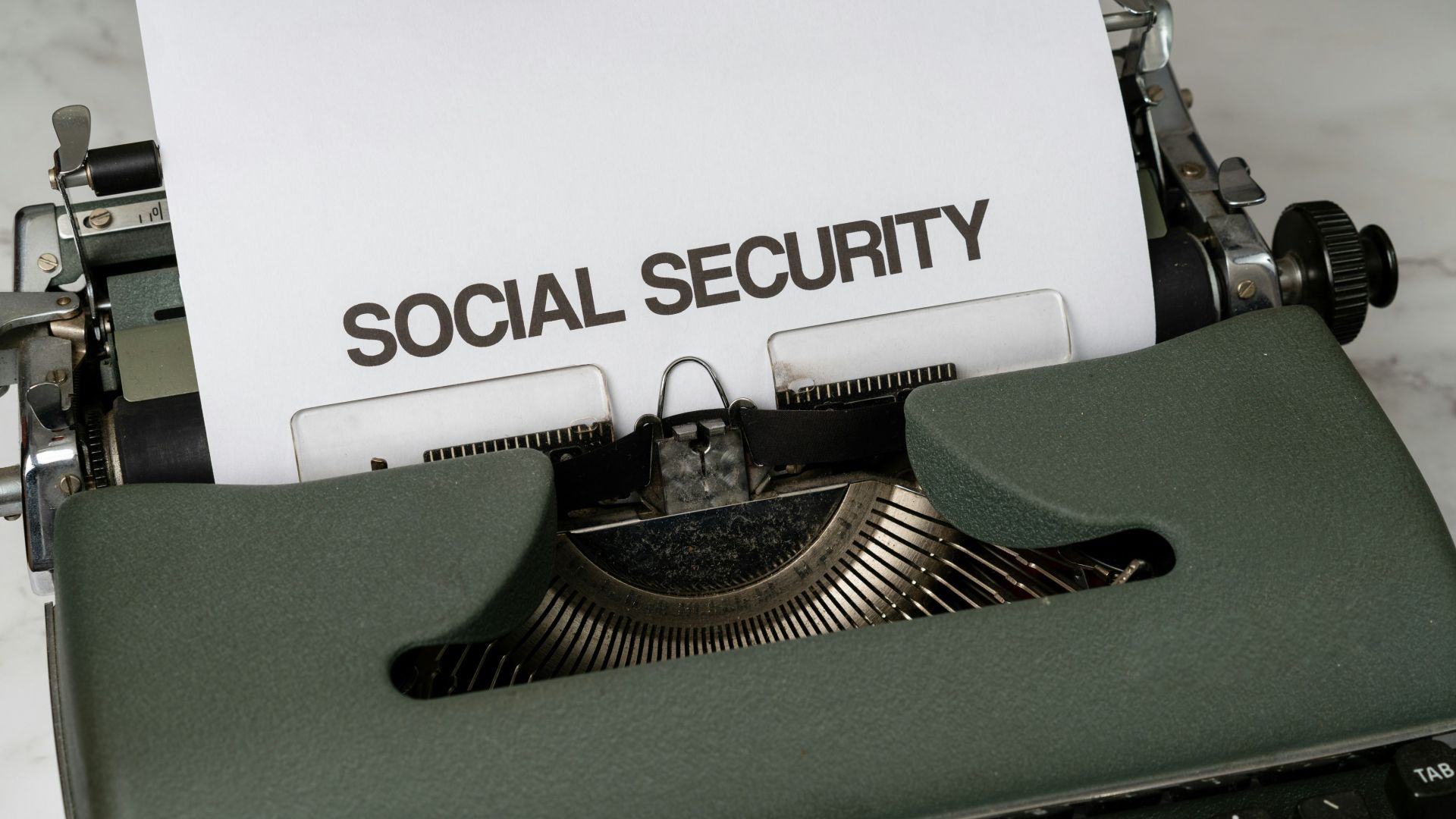 a close up of a typewriter with a paper that says social security