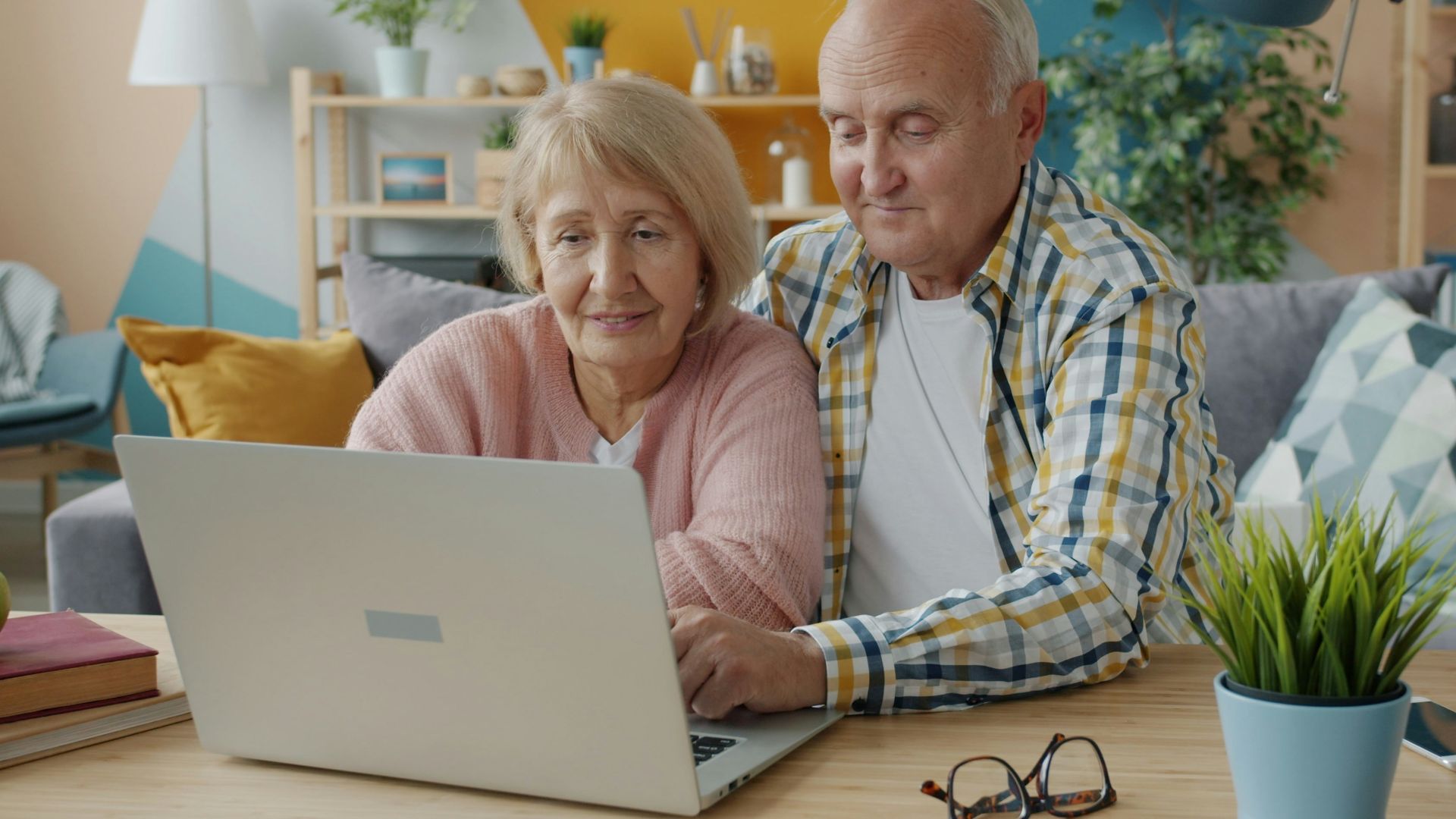 Elderly couple looking at a laptop together