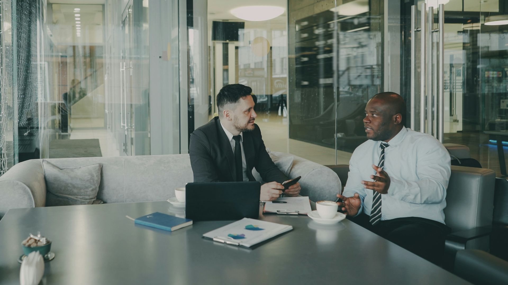 Two businessmen talking at a table