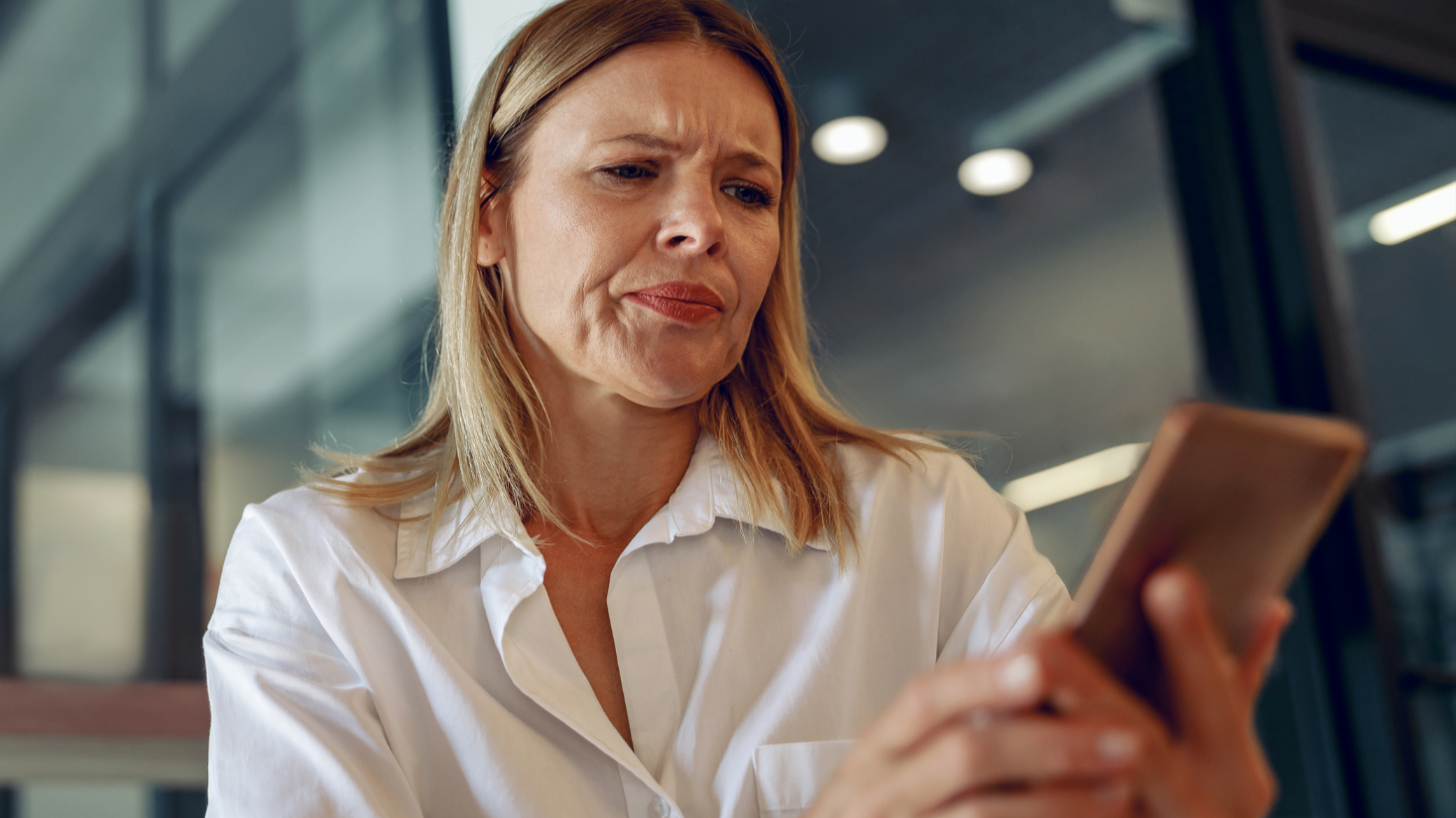 Worried woman manager holding phone