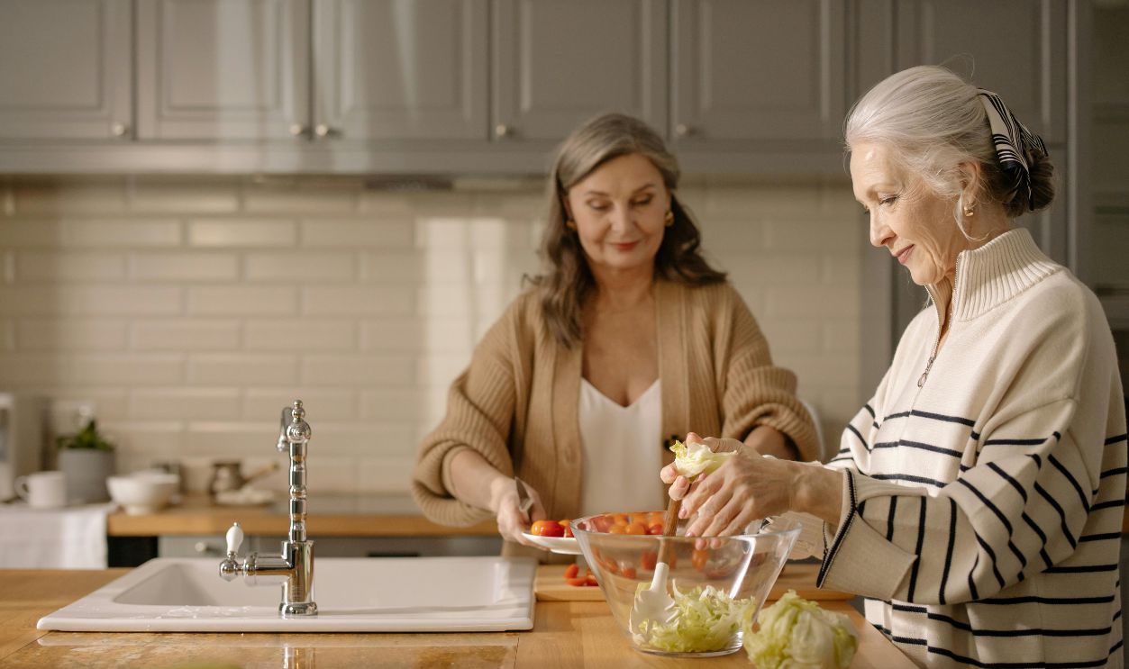 Two senior women making a fresh salad together