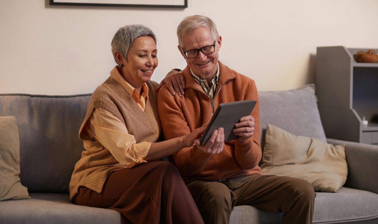 Happy senior couple sitting together on a sofa