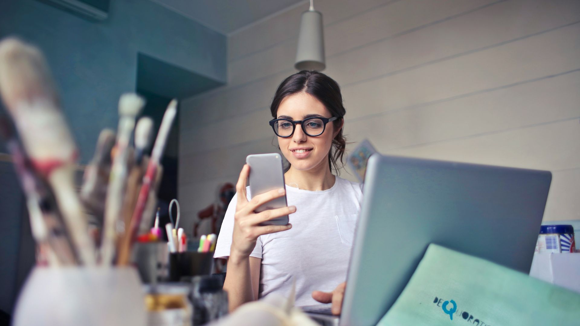 woman in white shirt using smartphone