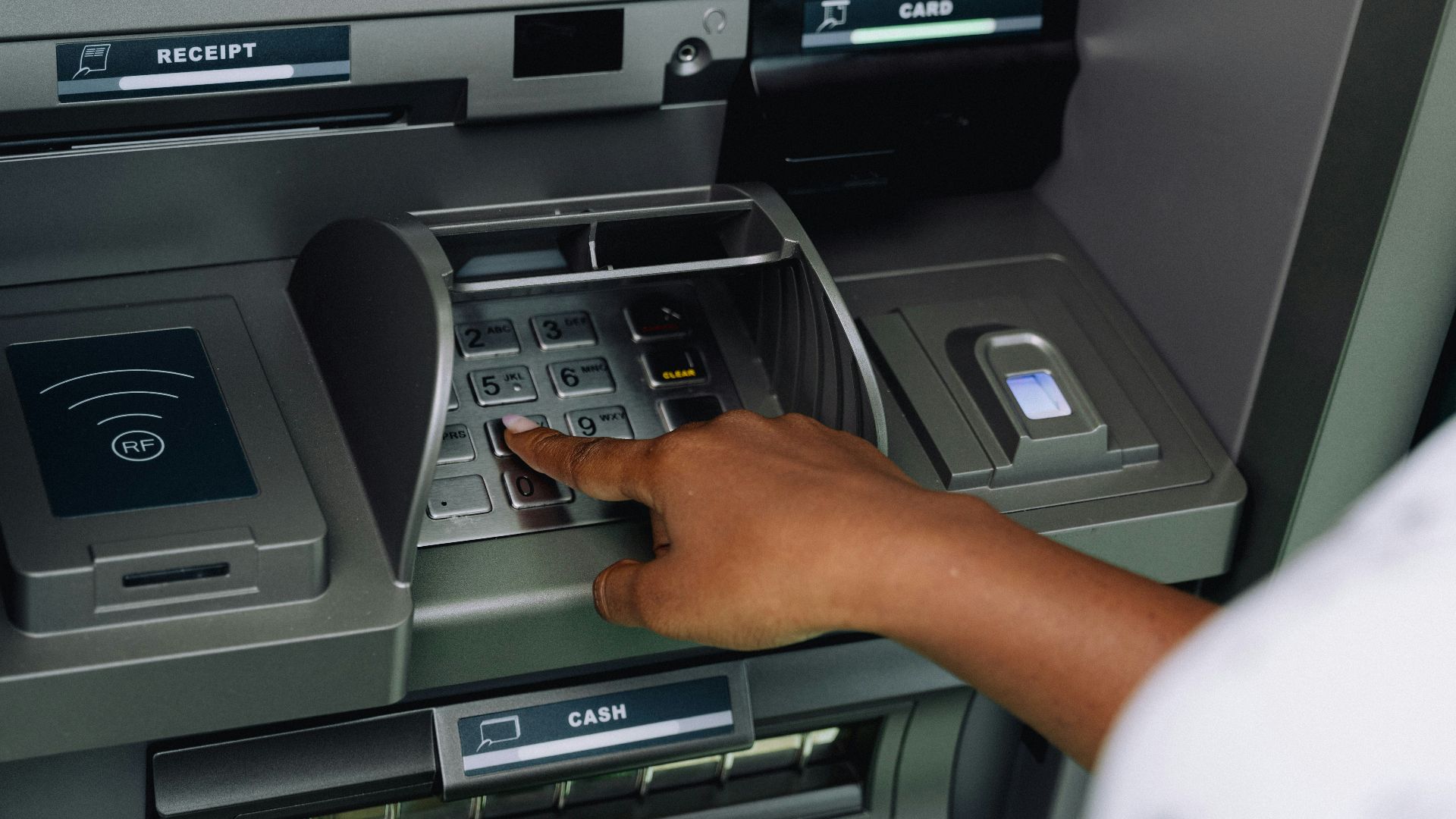 a person using an atm machine to pay money