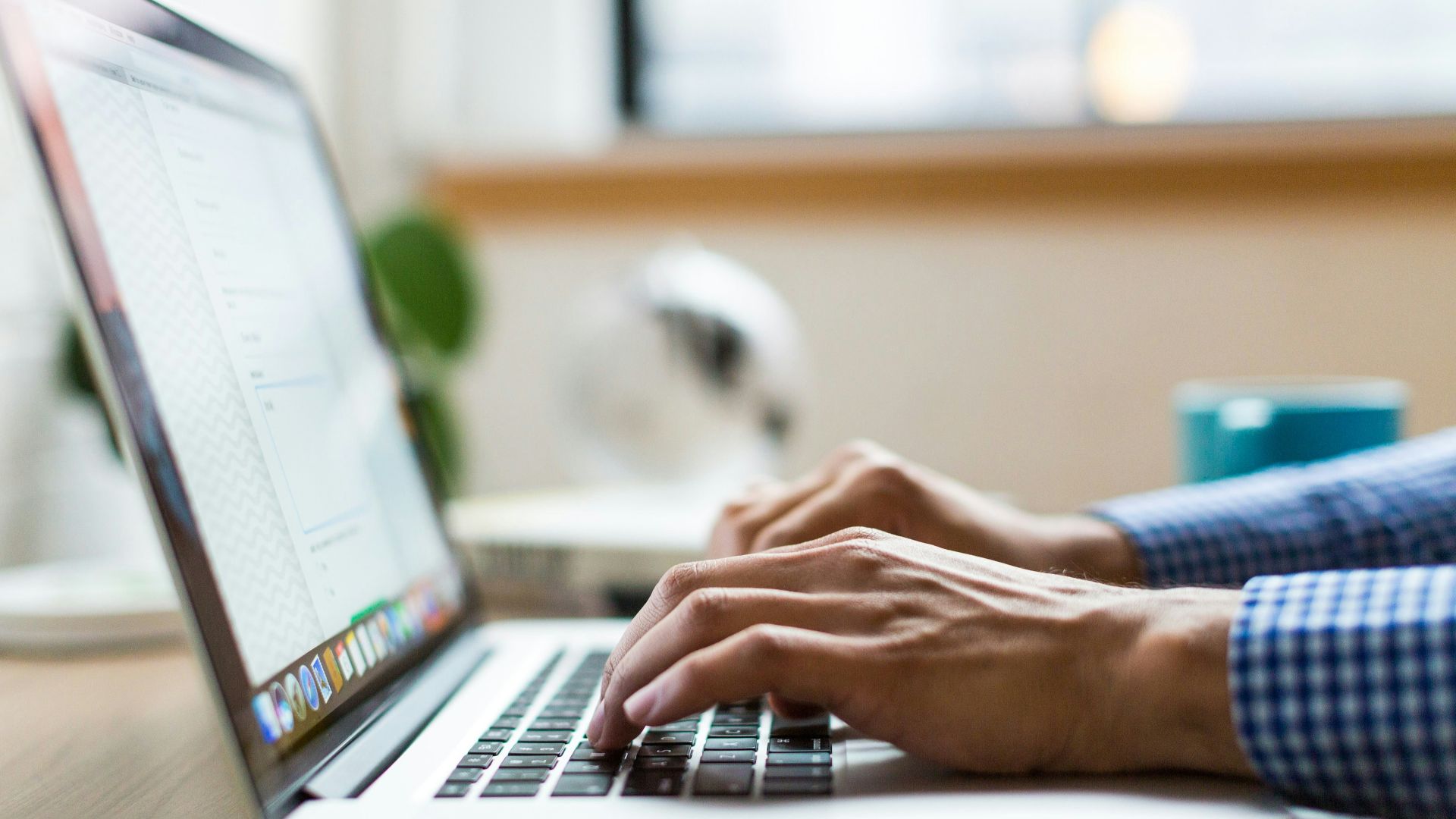 person typing on silver MacBook