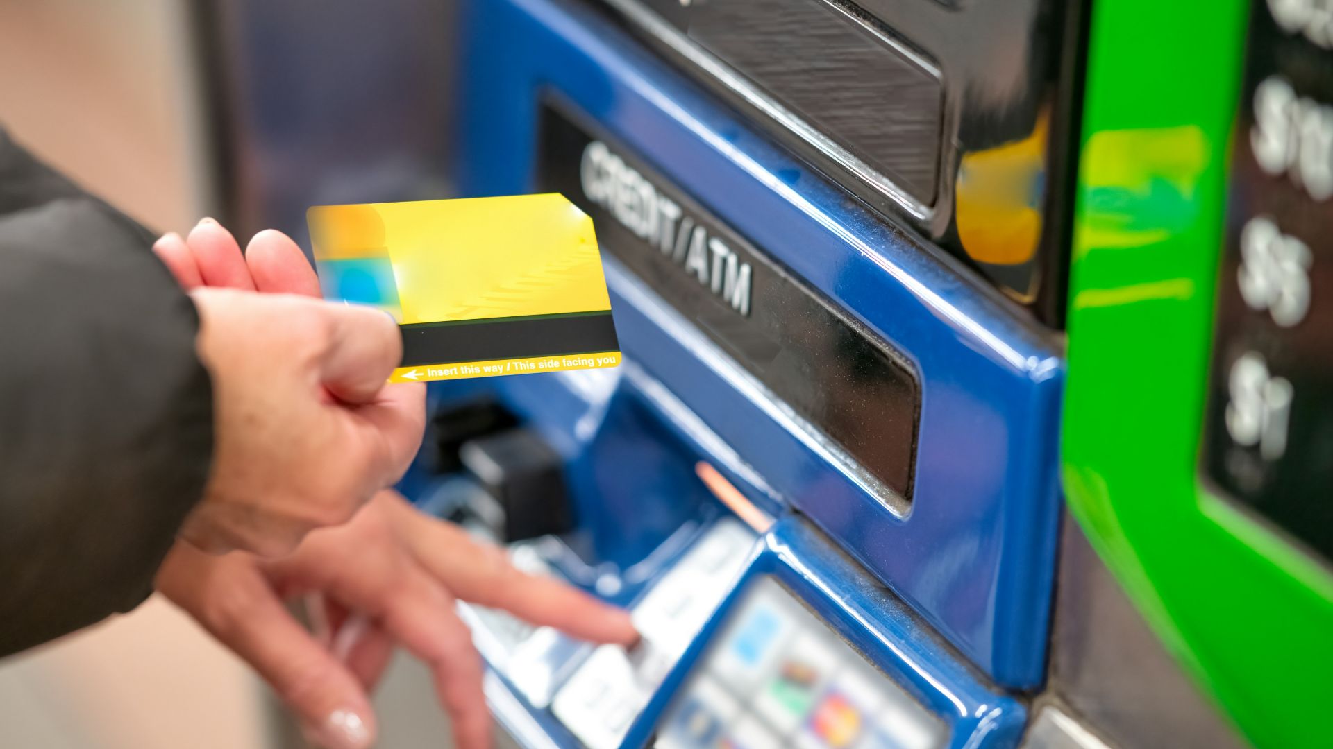 a person using a credit card to pay for a machine