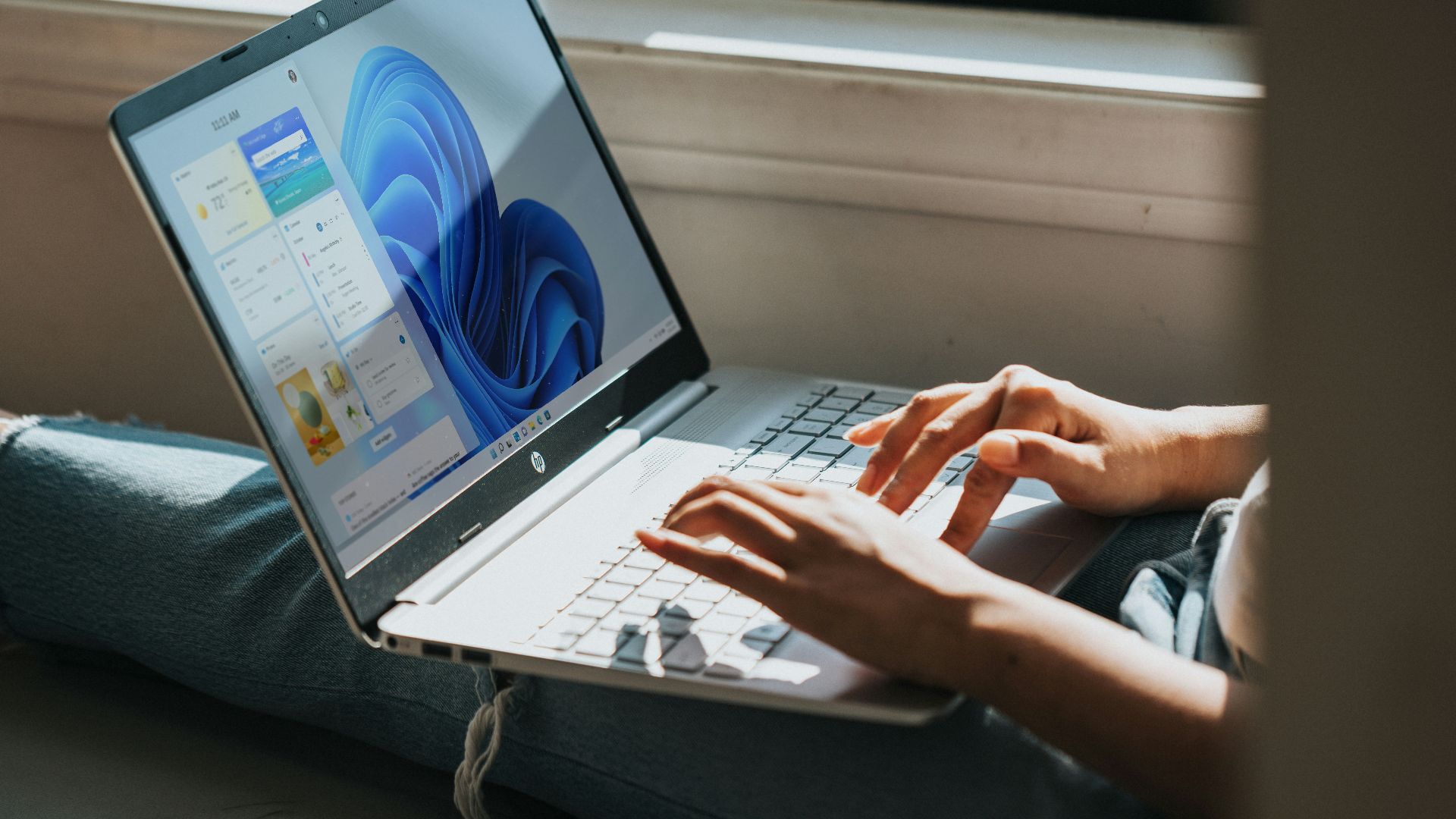 person using Windows 11 computer on lap