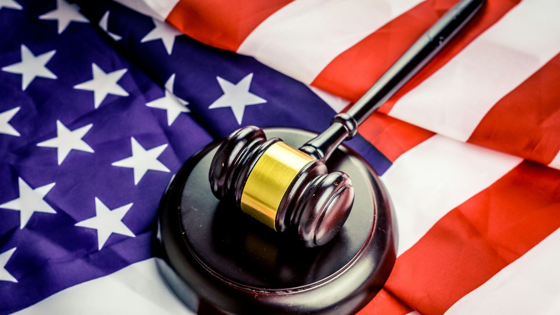 a judge's gavel on top of a flag