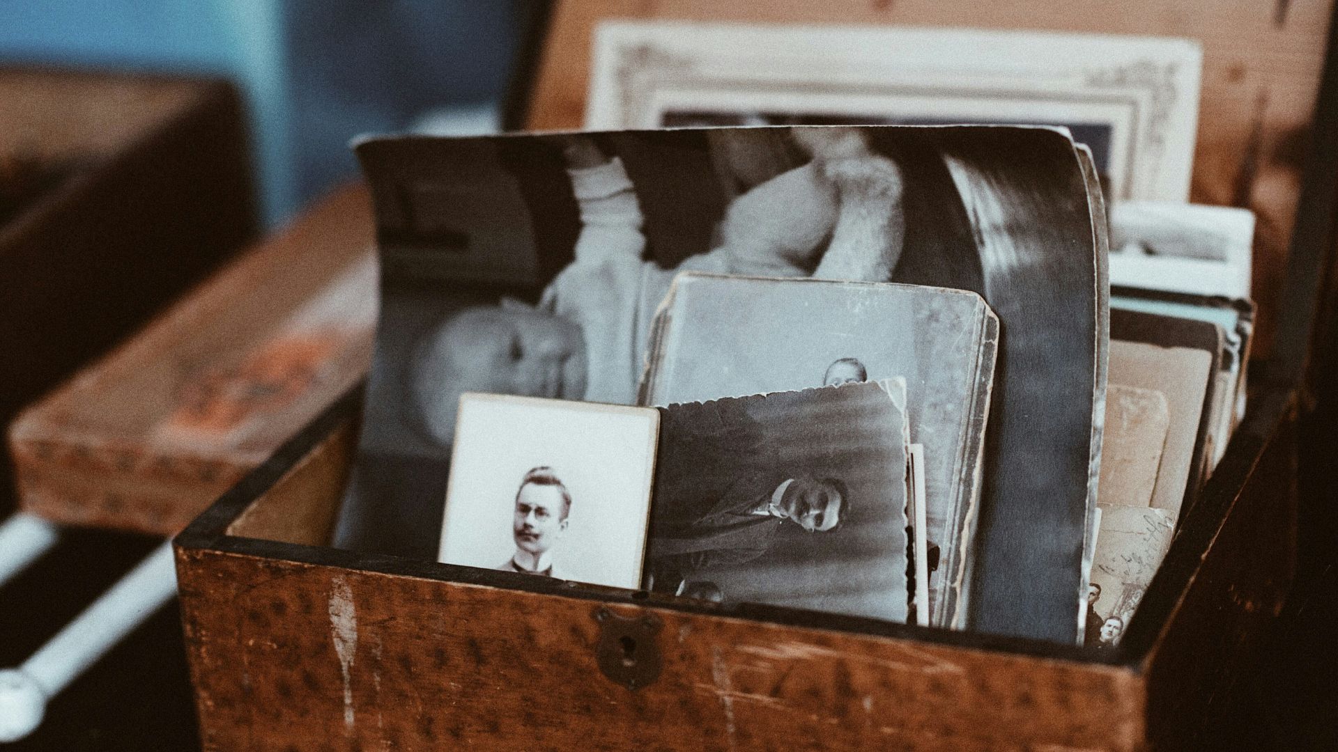 old photos in brown wooden chest