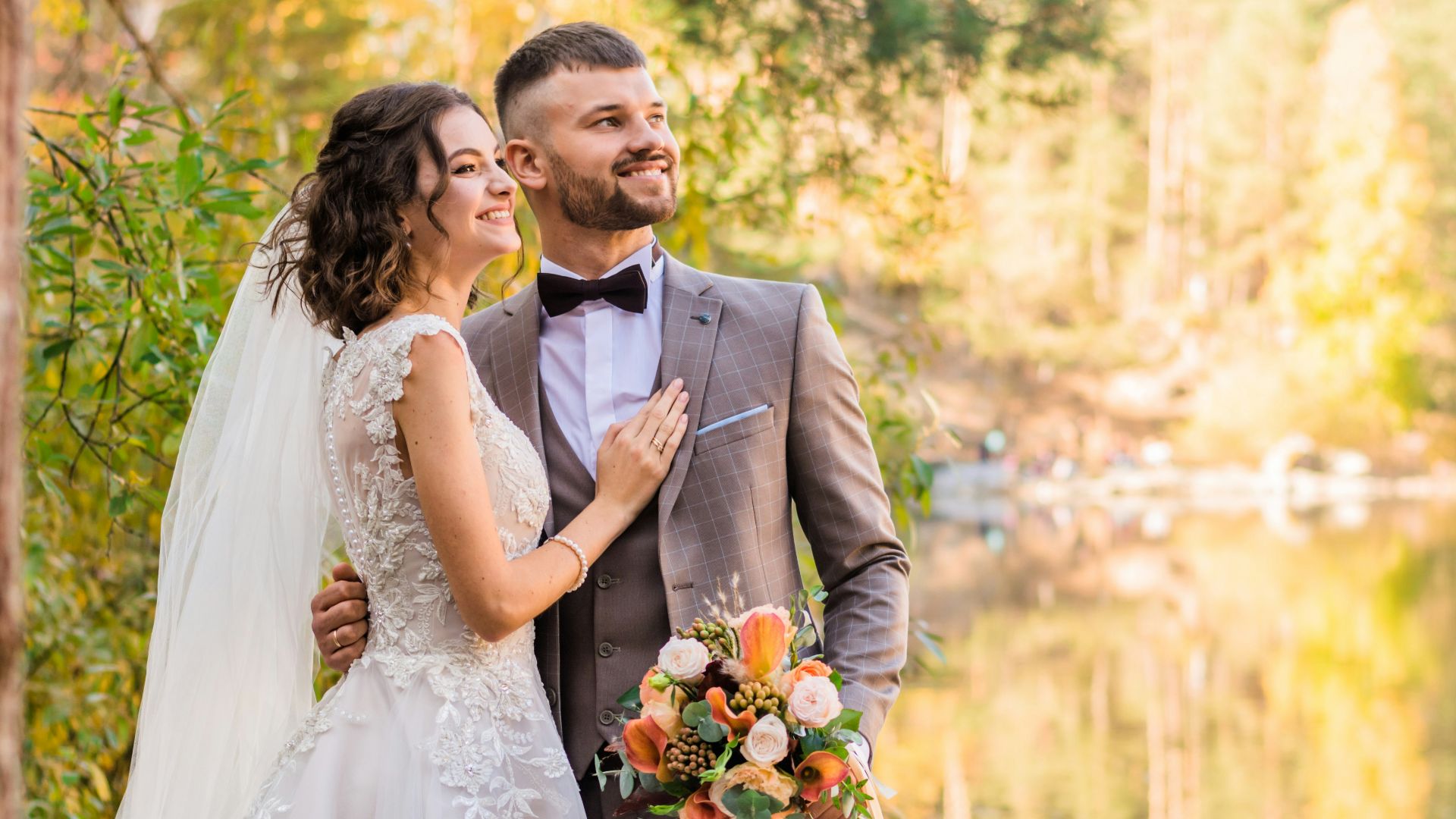 man in gray suit and woman in white wedding dress