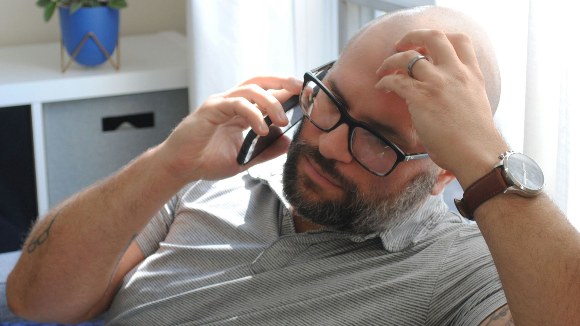 a man with glasses and a watch