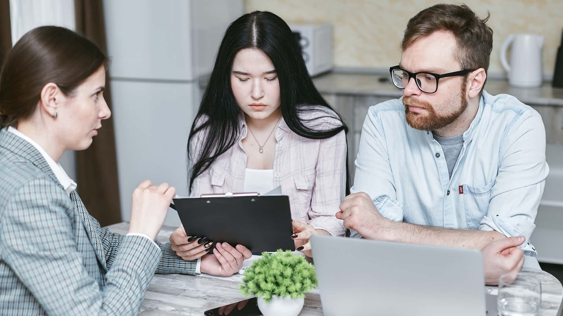 A group of professionals discussing business strategies at a table indoors.