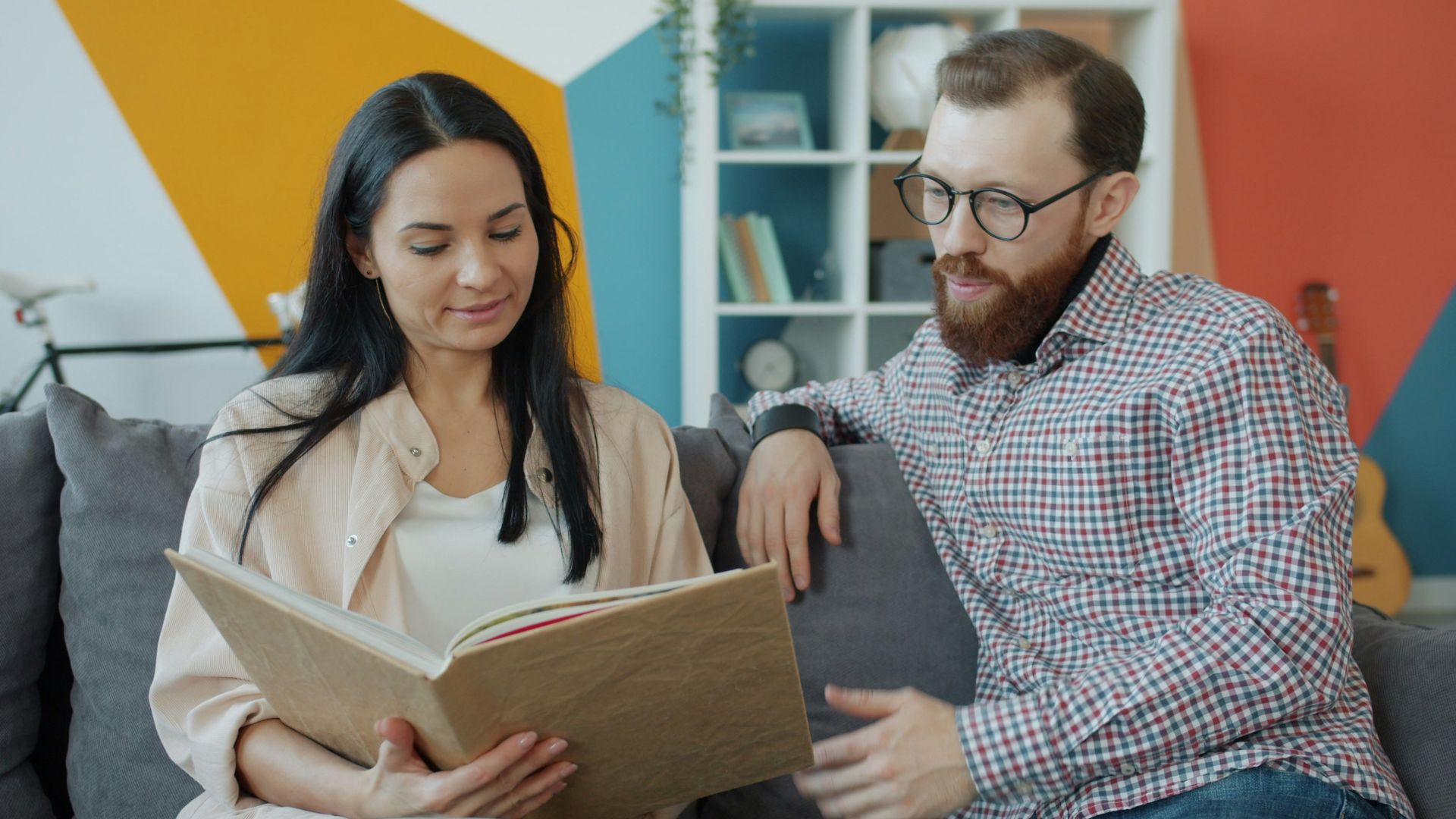 Couple looking at an open photo album together