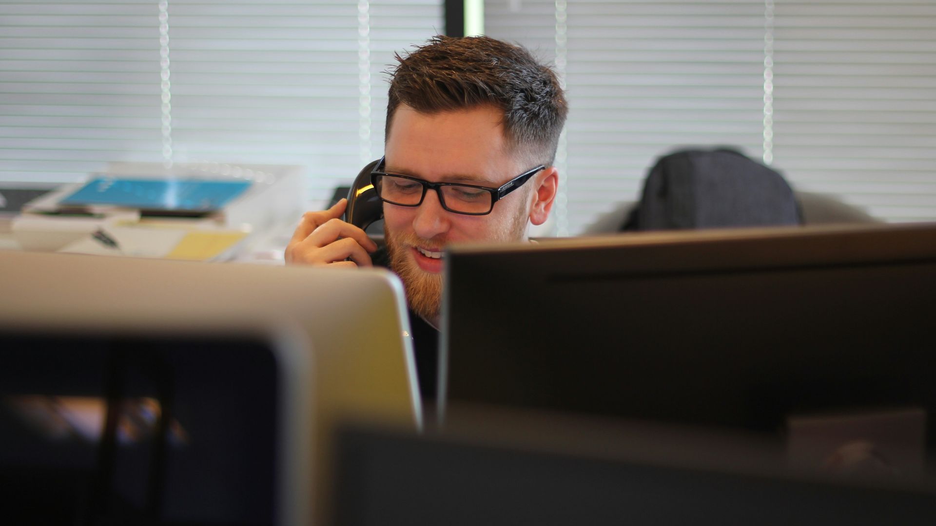 man using IP phone inside room