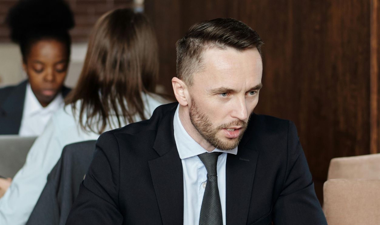 Professionals in suits having a focused business discussion in a stylish cafe