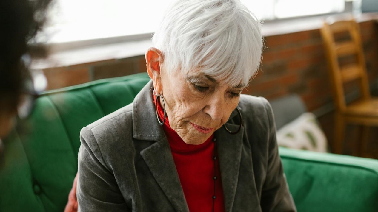 Elderly Woman Looking the Report Papers