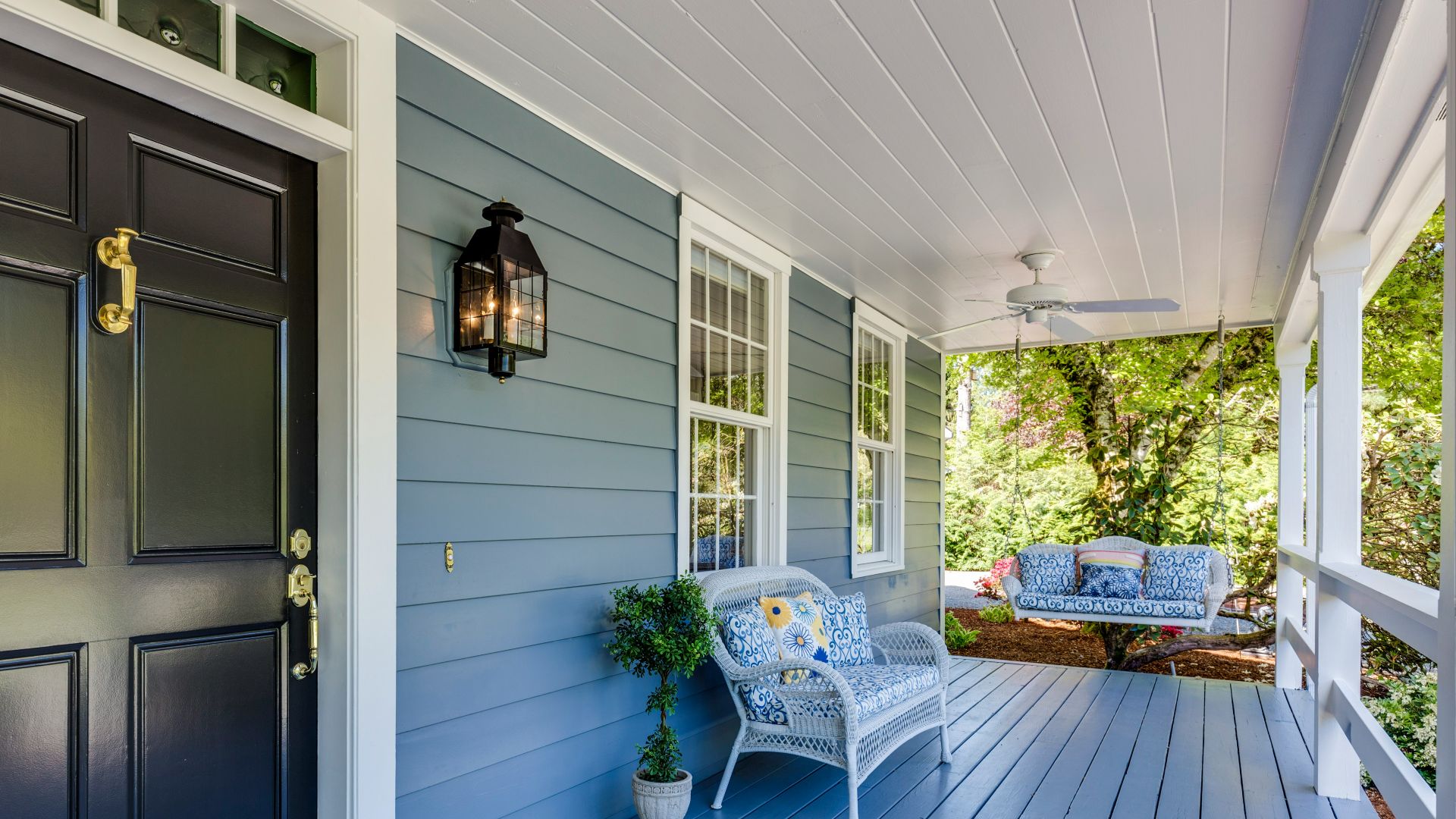 a porch with two chairs and a table on it