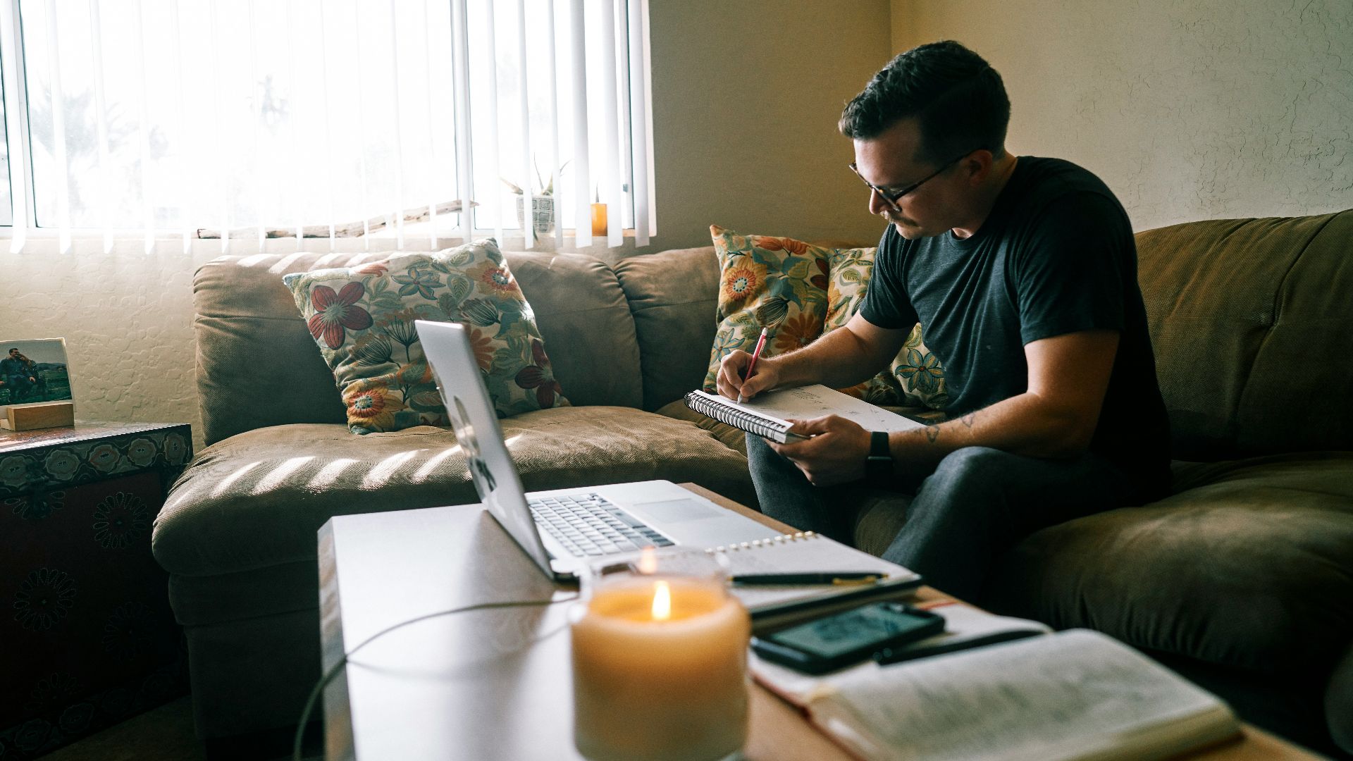 man in black crew neck t-shirt sitting on couch