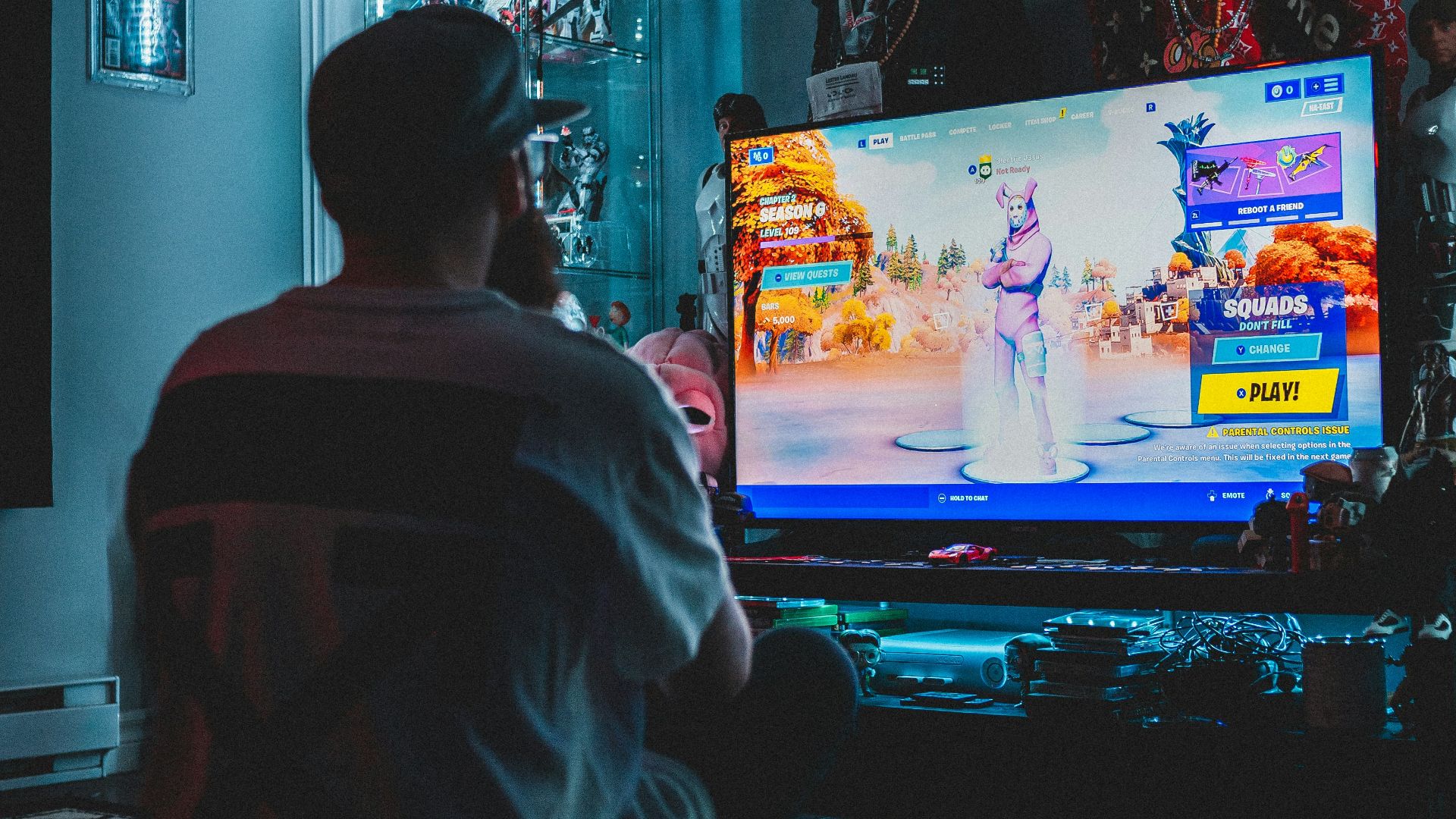 man in red shirt watching tv