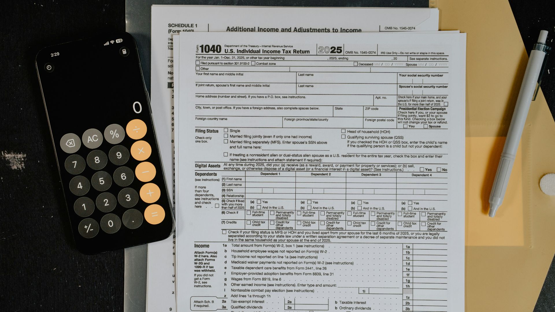 Tax forms and calculator on a desk.