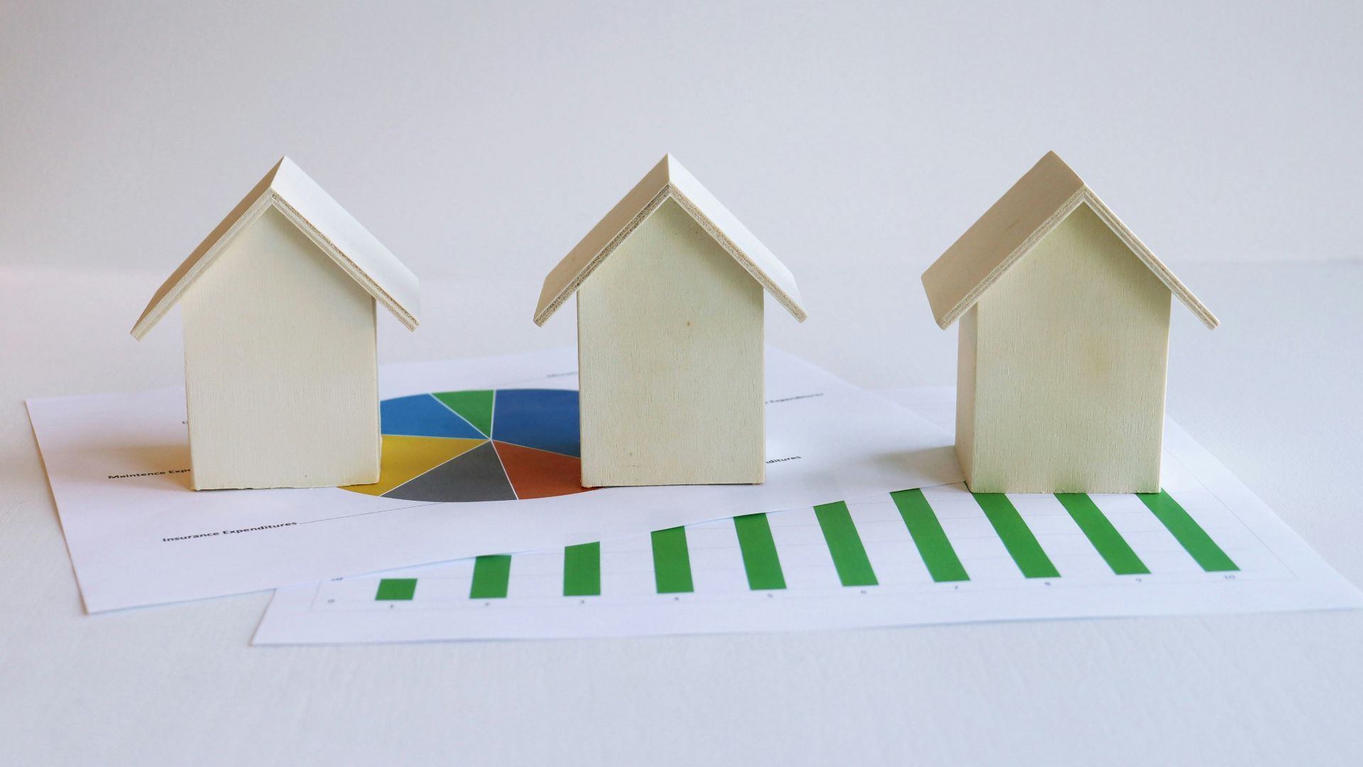 three small houses sitting on top of a piece of paper