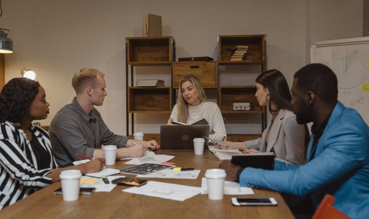 Business team discussing strategies in a modern office setting, focusing on collaboration.