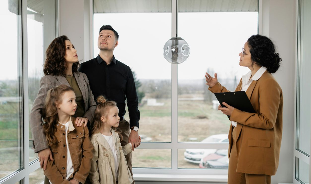 Family with children visits potential new home with a realtor