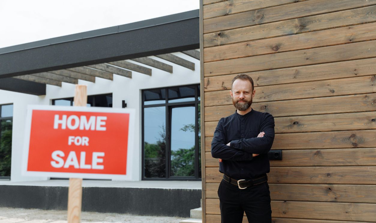 Real estate agent standing by a modern home