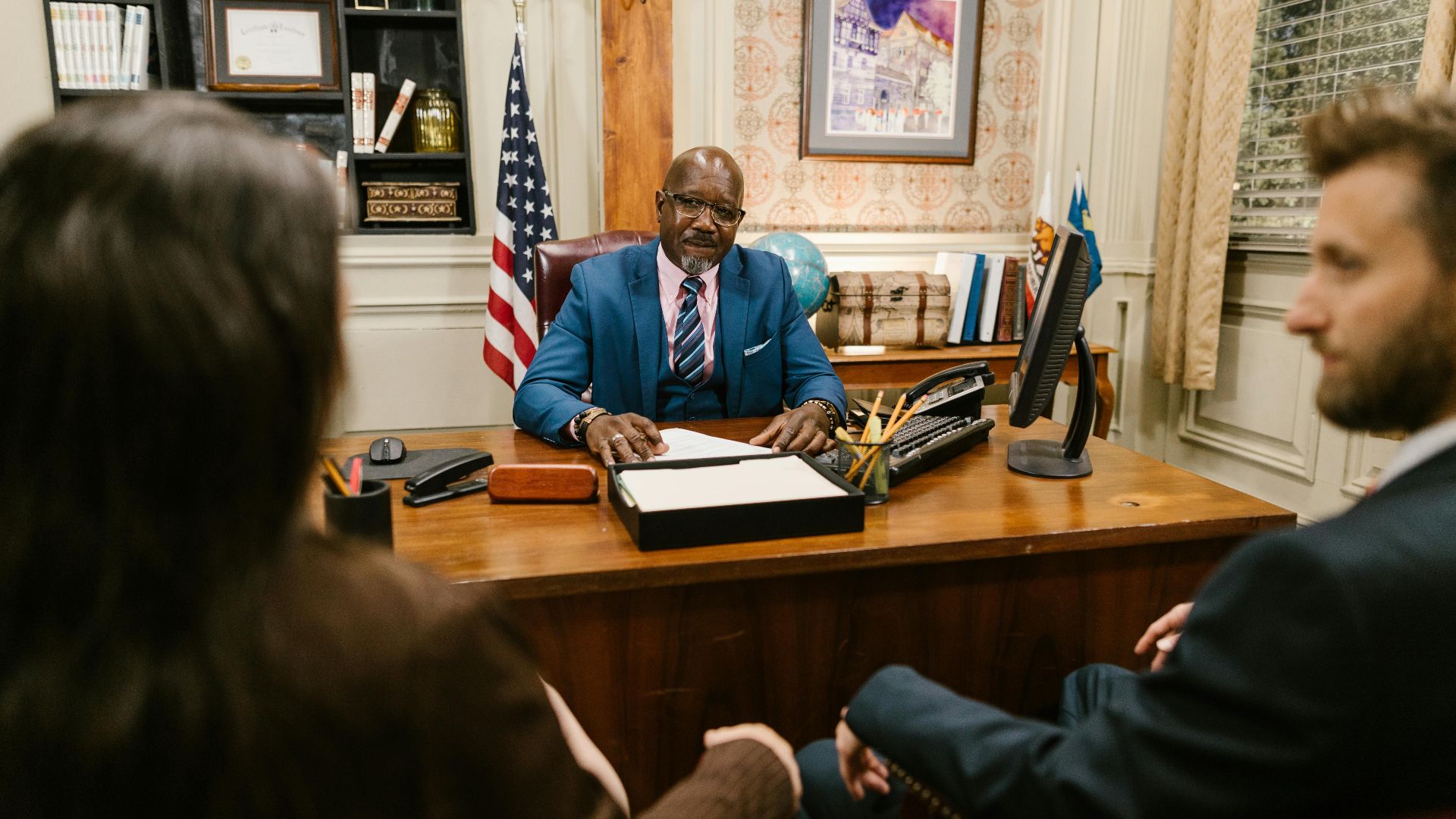 A professional lawyer meeting with clients in his office at a legal consultation.